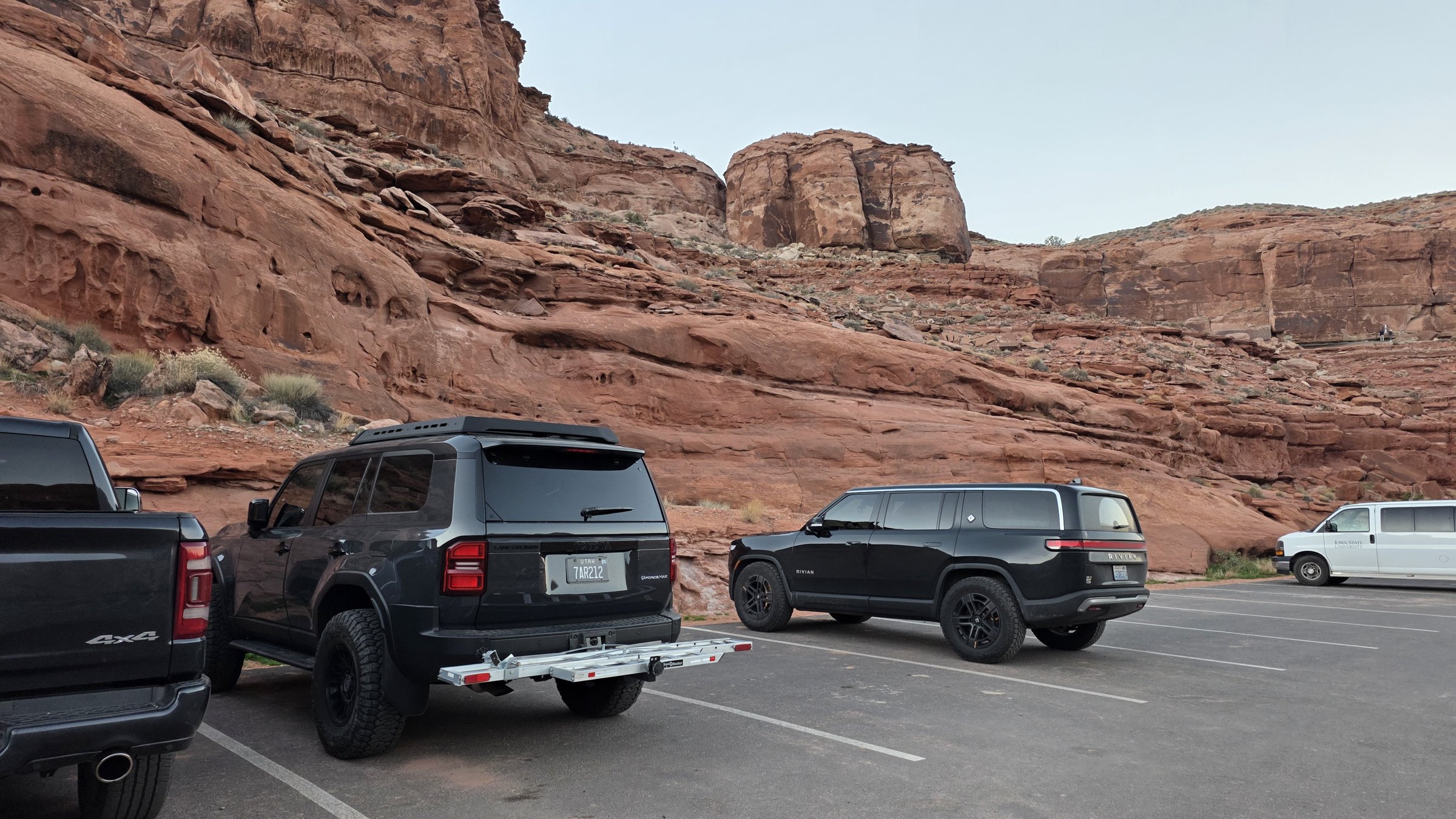 R1S parked at Potash Road trailhead with red rock walls