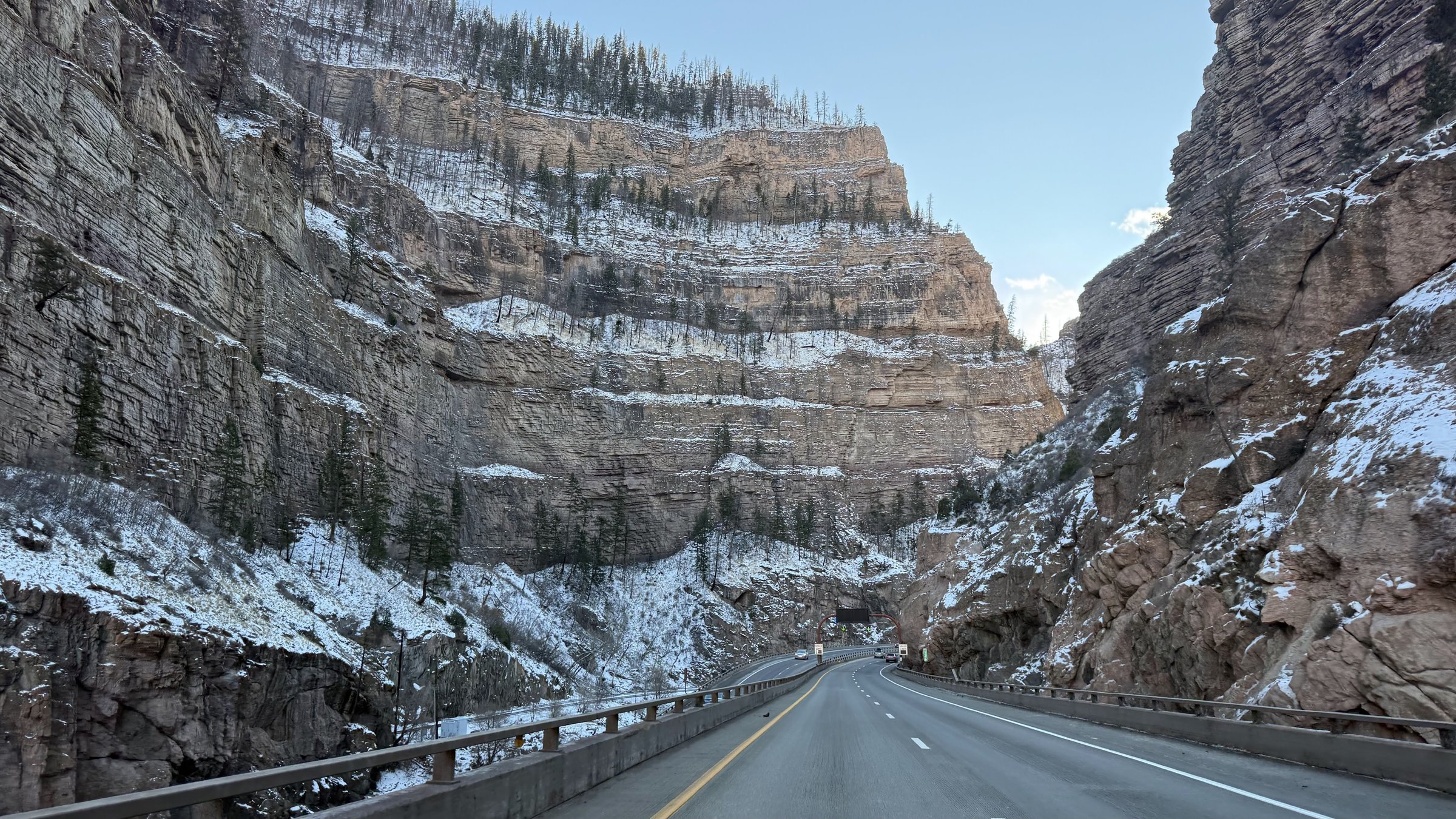 Glenwood Canyon on I-70 in winter with towering rock walls and snow