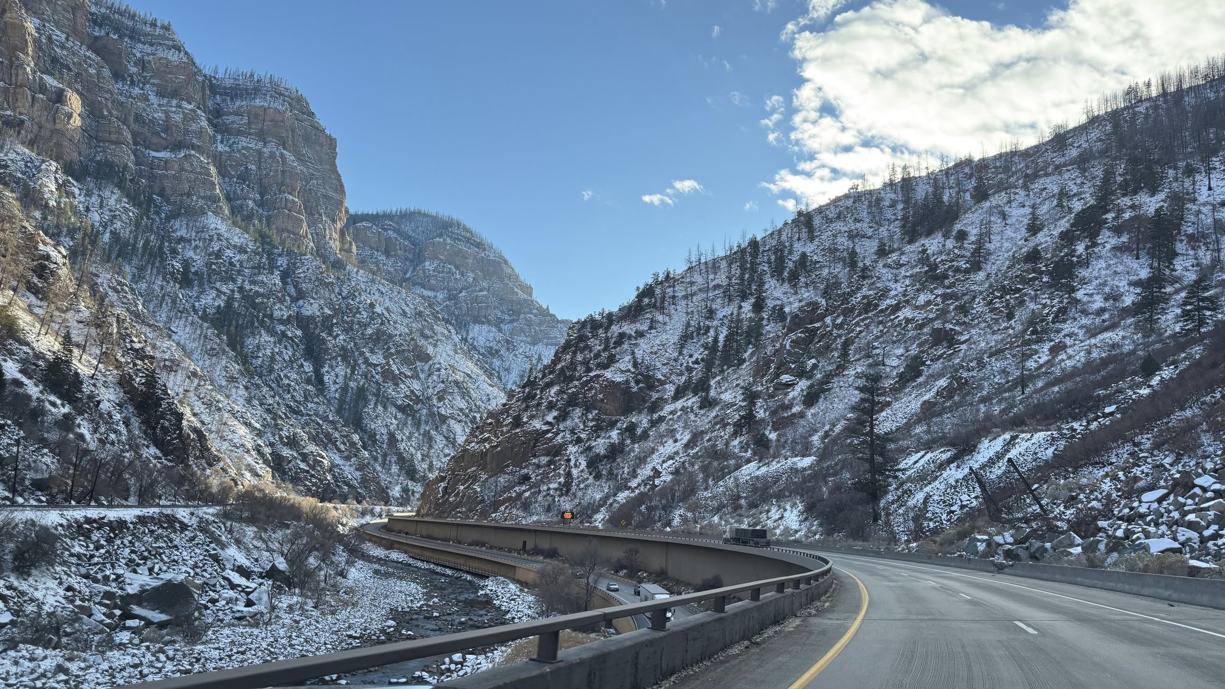 Glenwood Canyon winding road with Colorado River and snow-covered walls